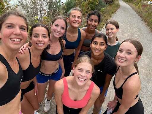 Members of the team smile for the camera after a run at a trail next to Mullet Lake.