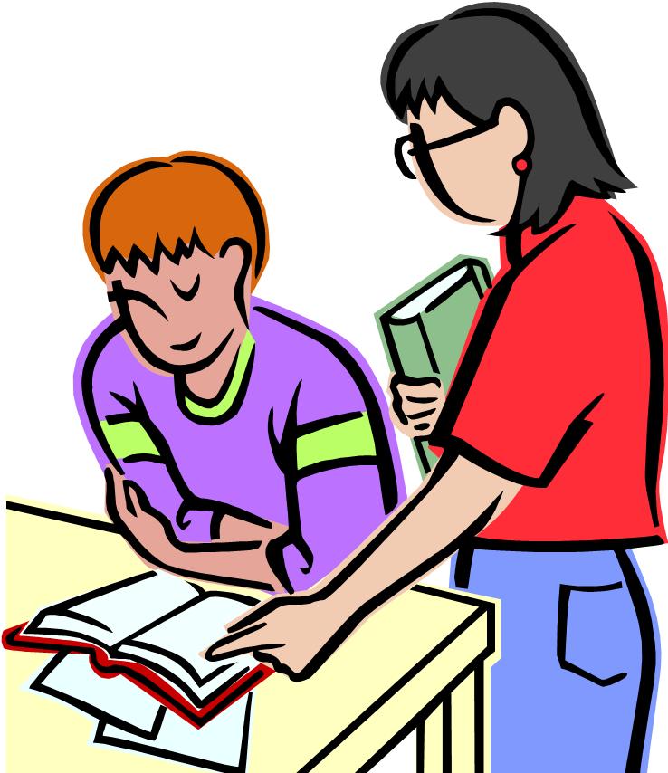 Teacher in red shirt standing by student seated at a desk helping the student