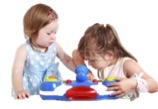 Two children with builiding blocks at a table