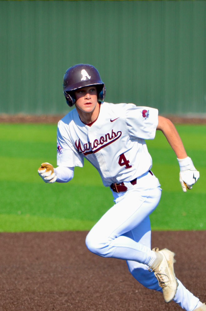 This is a photo of Austin High Maroons baseball player running the bases.