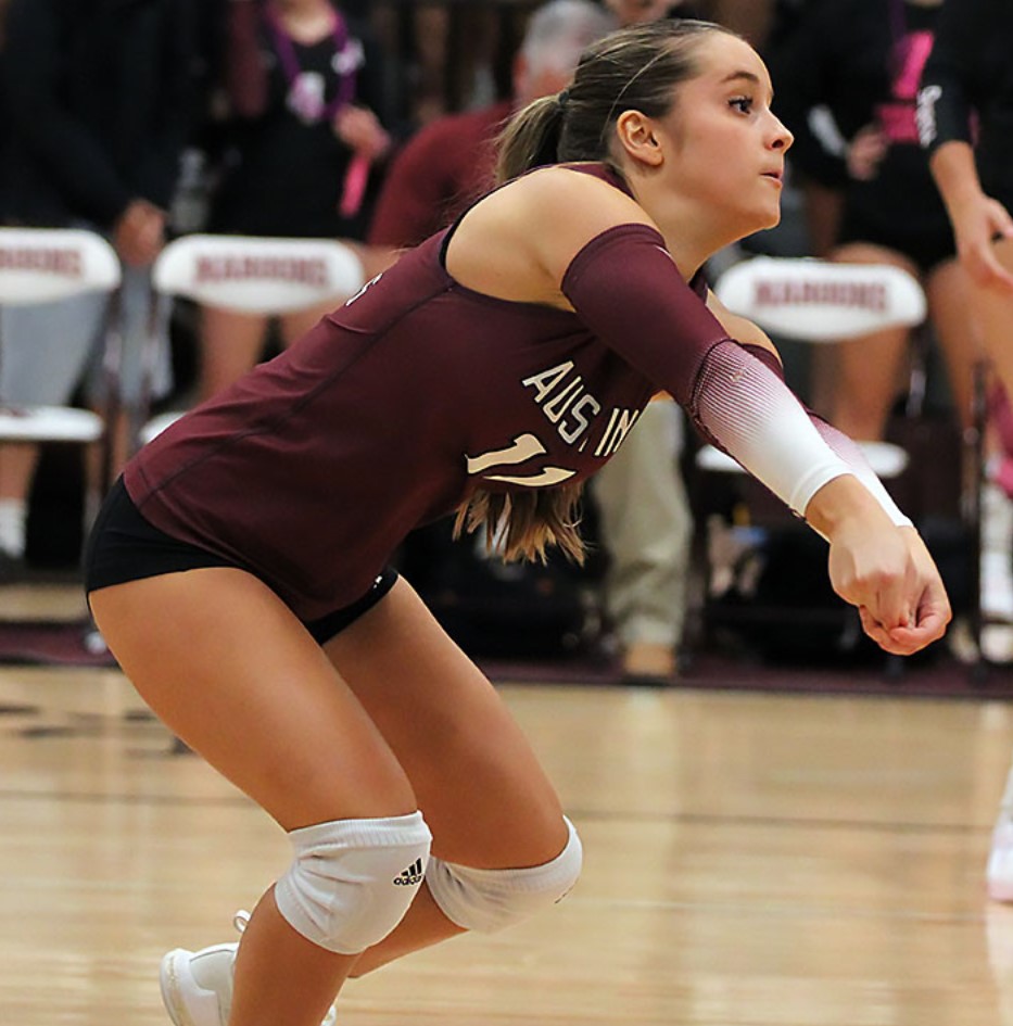 This is a photo of Austin High Maroons volleyball player hitting ball.