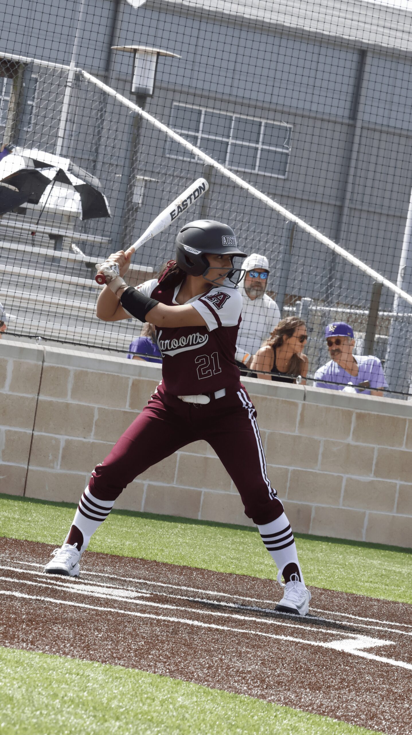 This is a photo of Austin High softball player hitting the ball.