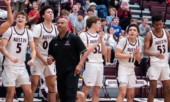 AHS Boys basketball team photo here of Coach Jones and his boys on bench.