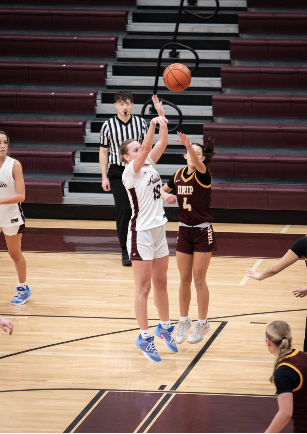 Foley shooting the basketball for Lady Maroons athletics.
