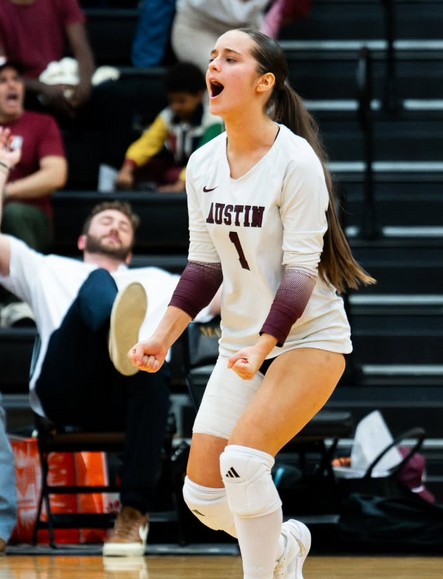 Austin High Maroons volleyball player on court at home gym