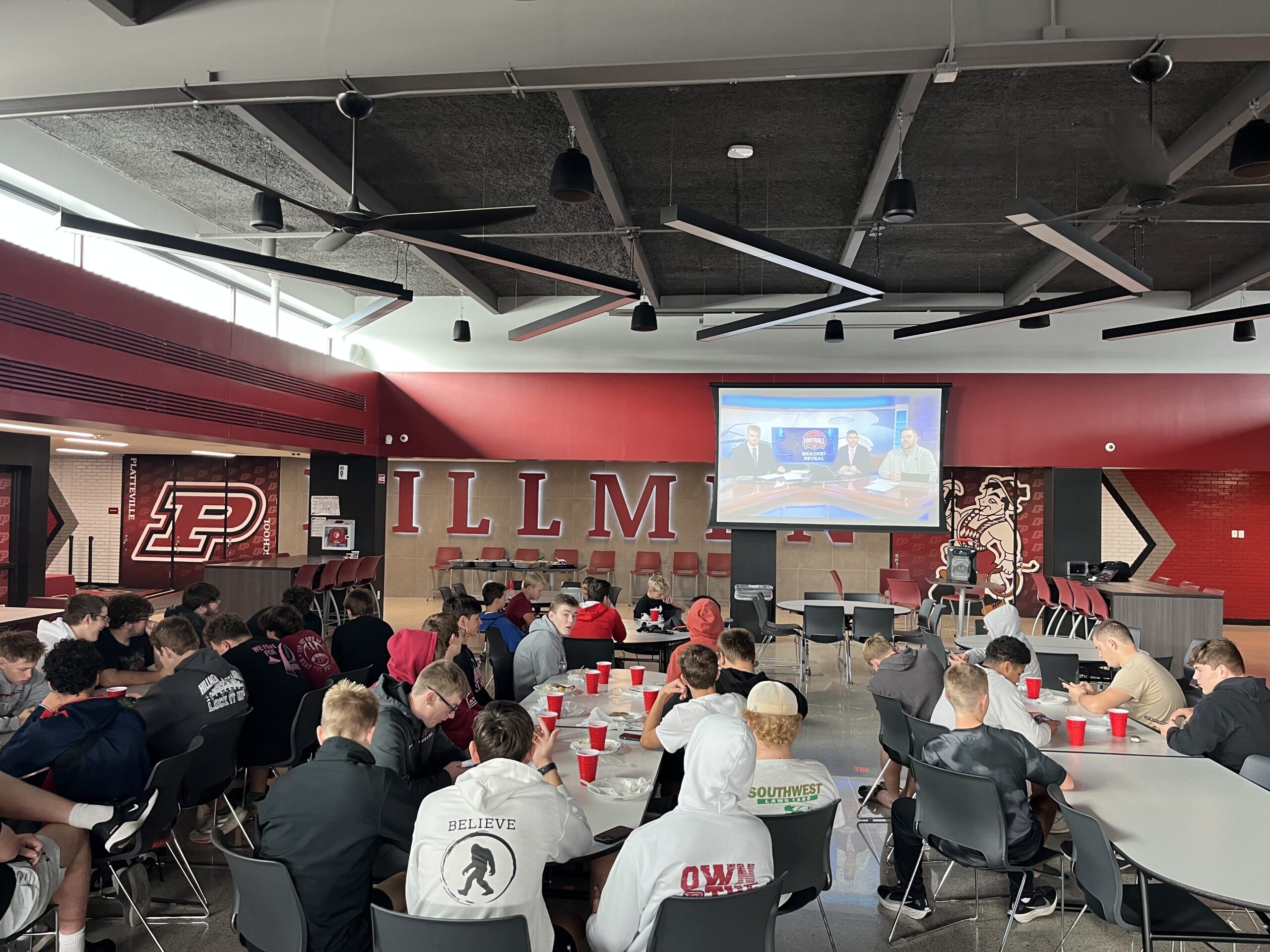 The Platteville Hillmen Football Team watches to see who their level one matchup will be in the WIAA playoffs