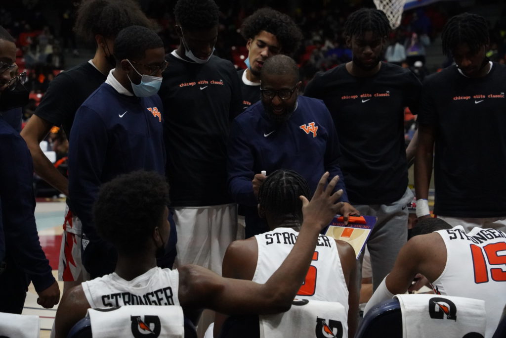 Whitney Young head coach Tyrone Slaughter strategizes with players.