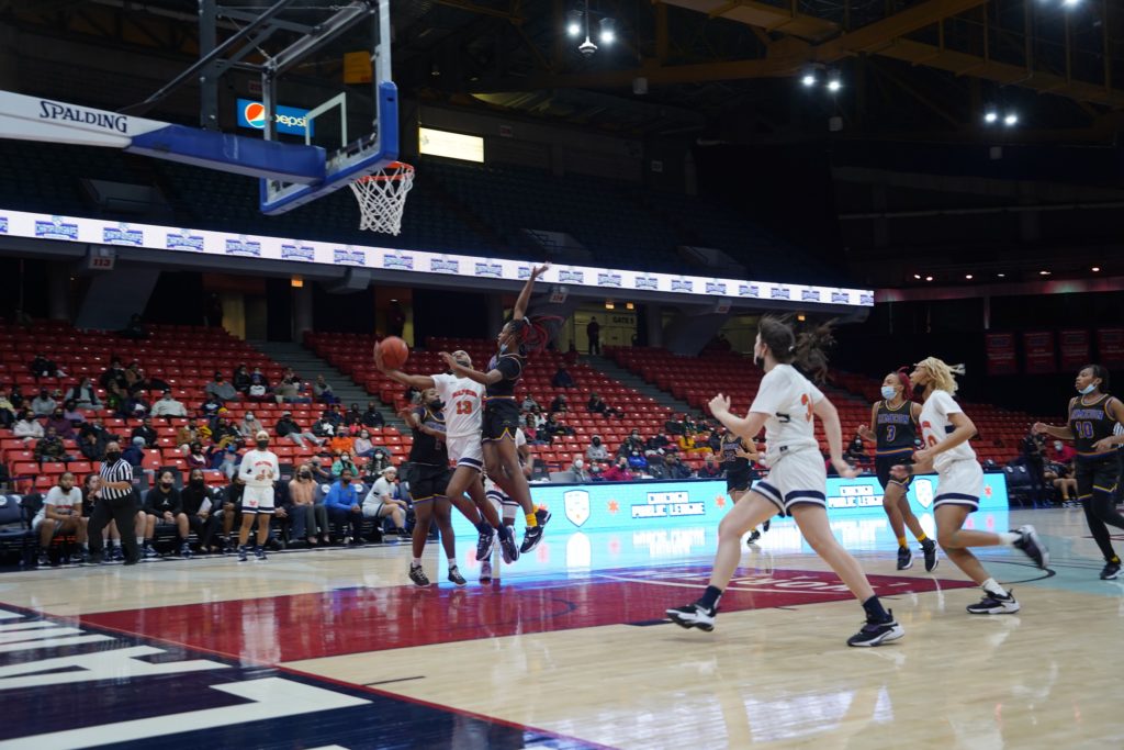 Whitney Young junior center Skylar Jones drives to the hoop during the Lady Dolphins' semifinal match against Simeon