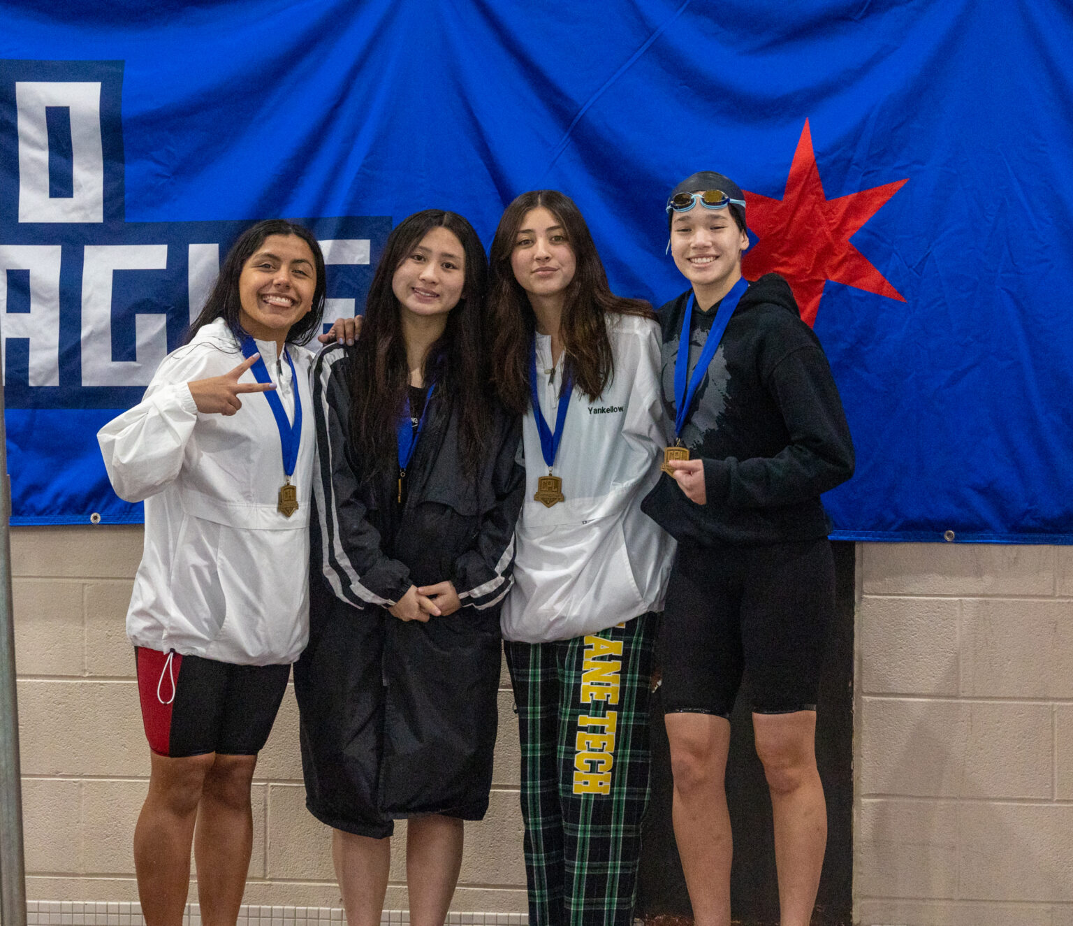 Young breaks through, sweeps girls swimming city titles; 13 entries