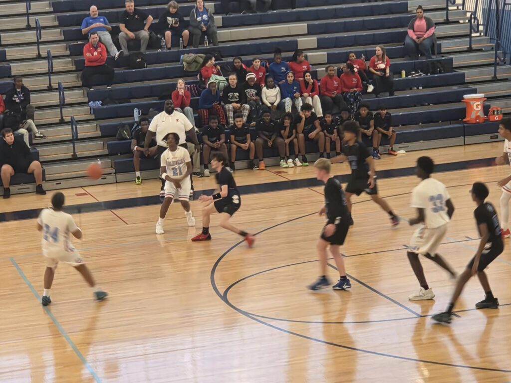 Basketball players passing a ball during a game.