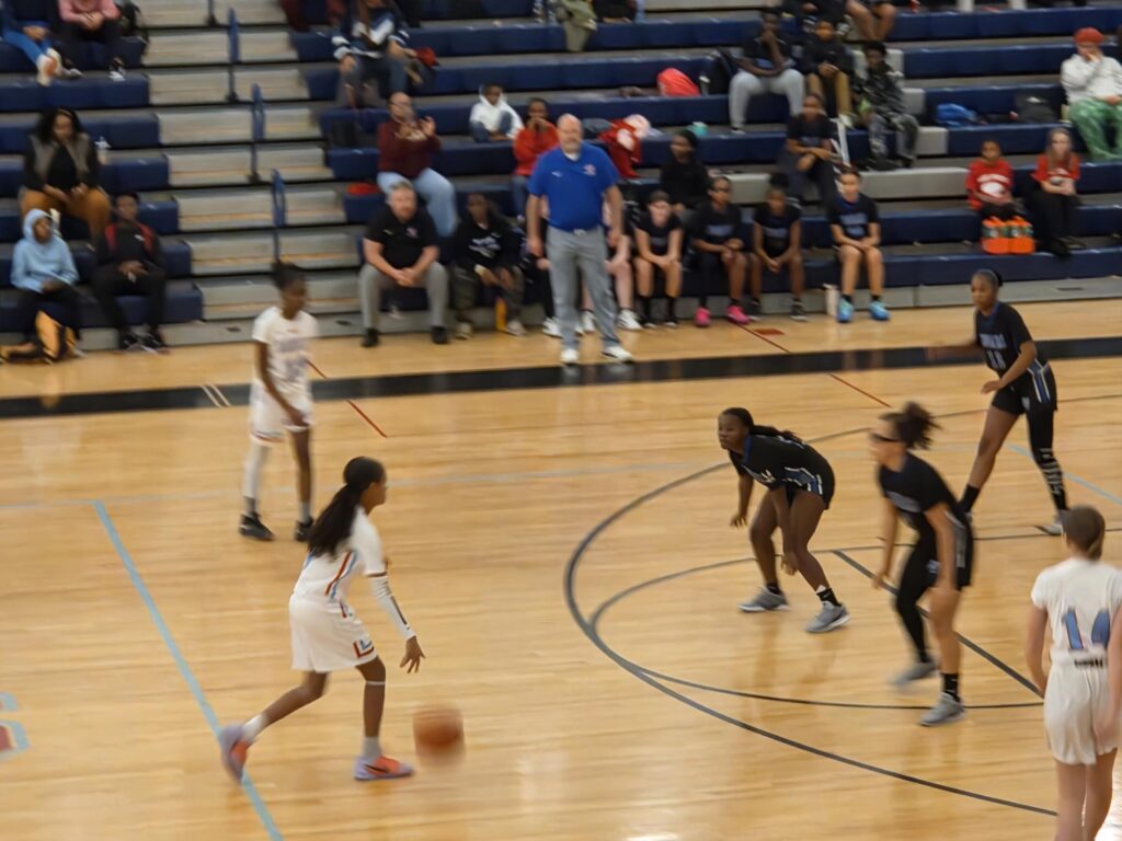 Girls basketball players playing a game.