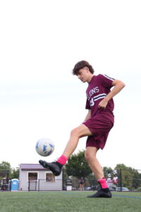 Logan Henzes with soccer ball