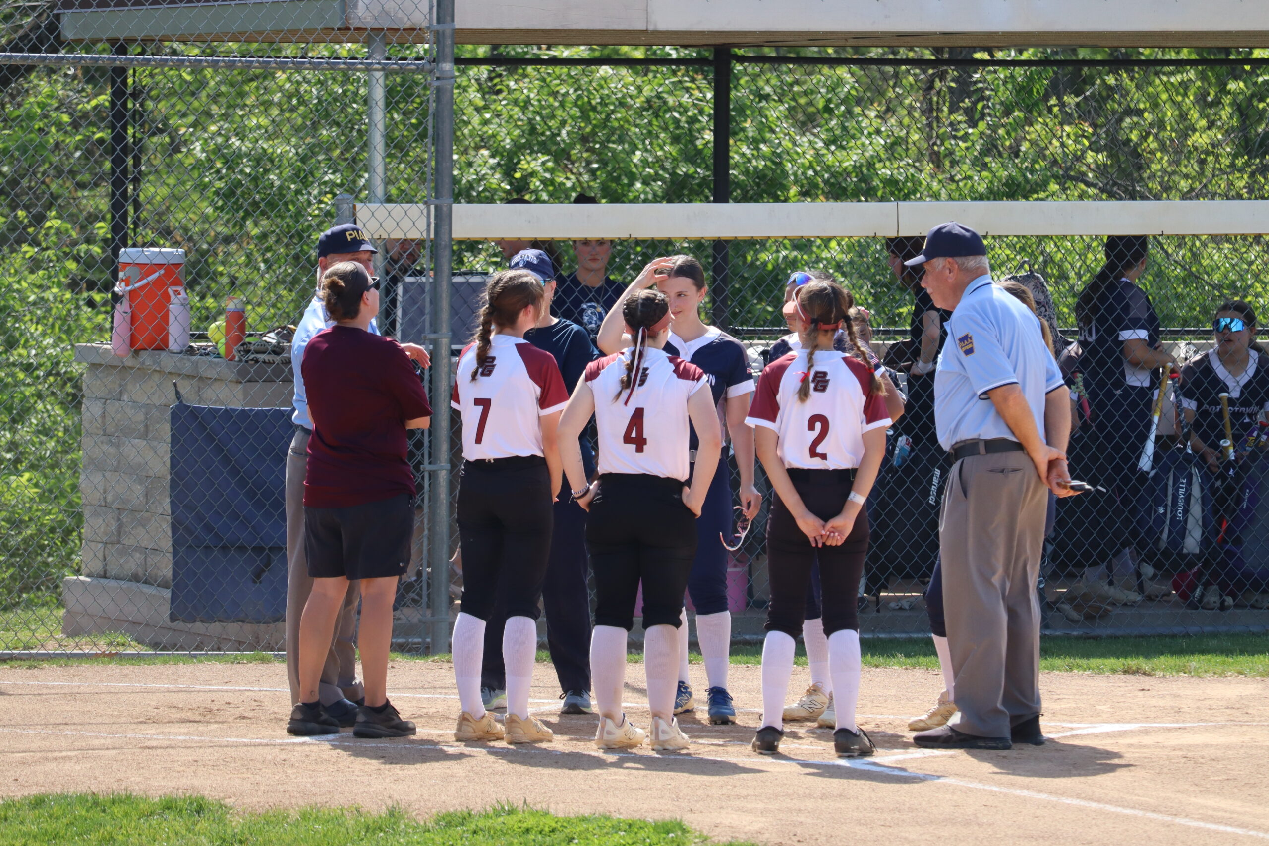 Softball players with umpires