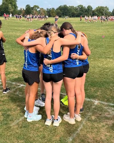 Denver Christian cross country runners huddle before a race