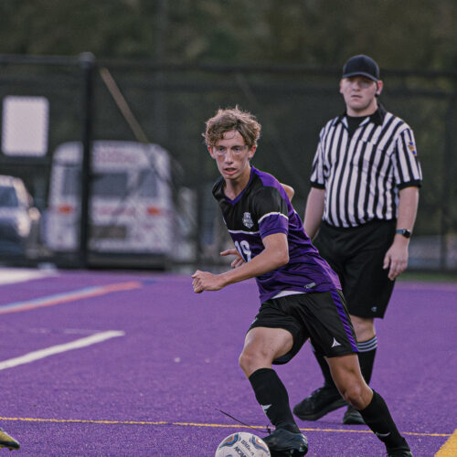 Soccer player about to kick the soccer ball down the field