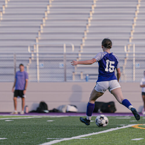 Soccer player is about to kick the soccer ball on a field.