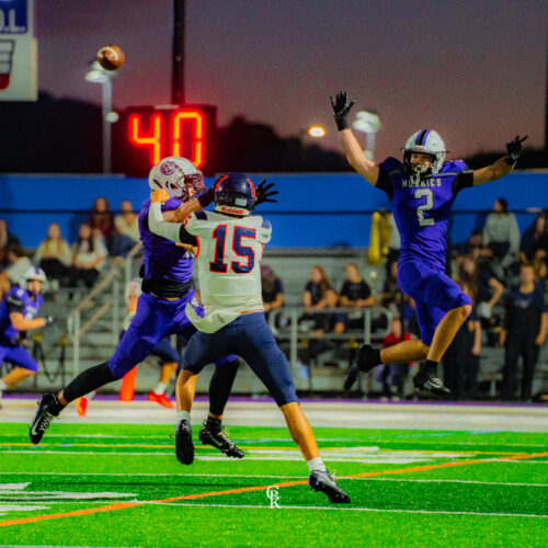 2 football players running with the ball