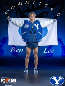 Ben Lee wearing BYU gear and a BYU flag announcing his commitment to run track and cross country.