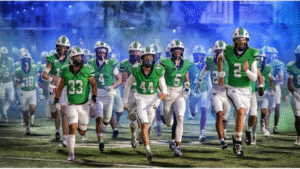 ThunderRidge Football players running through the blue smoke.