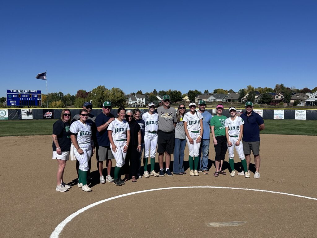 Softball Seniors posing with their parents on Senior Day vs Highlands Ranch.