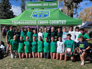 Boys and Girls Cross Country Regional Team Members pose for a picture in front of the ThunderRidge tent.