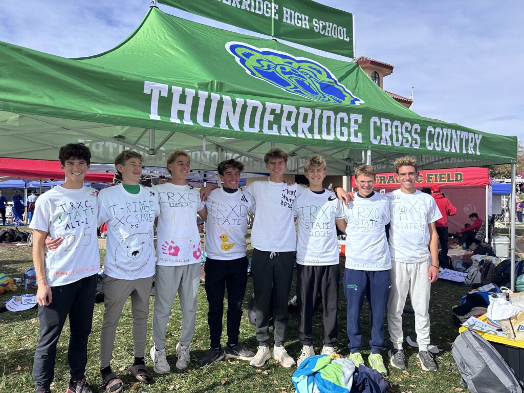 Boys Cross Country Runners pose for pictures.