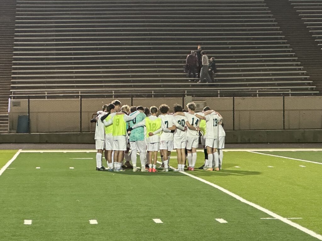 Boys Soccer Team Huddles Up after their playoff game versus Boulder.