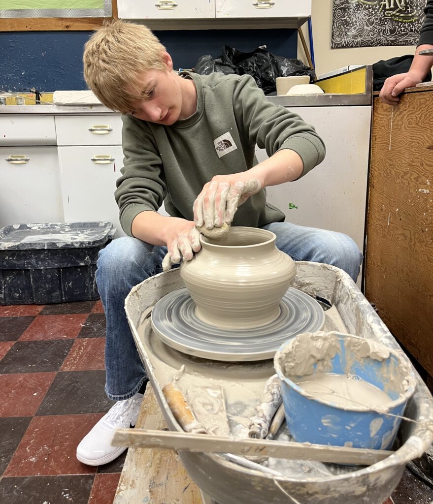 Gavin Willardson works on the pottery wheel
