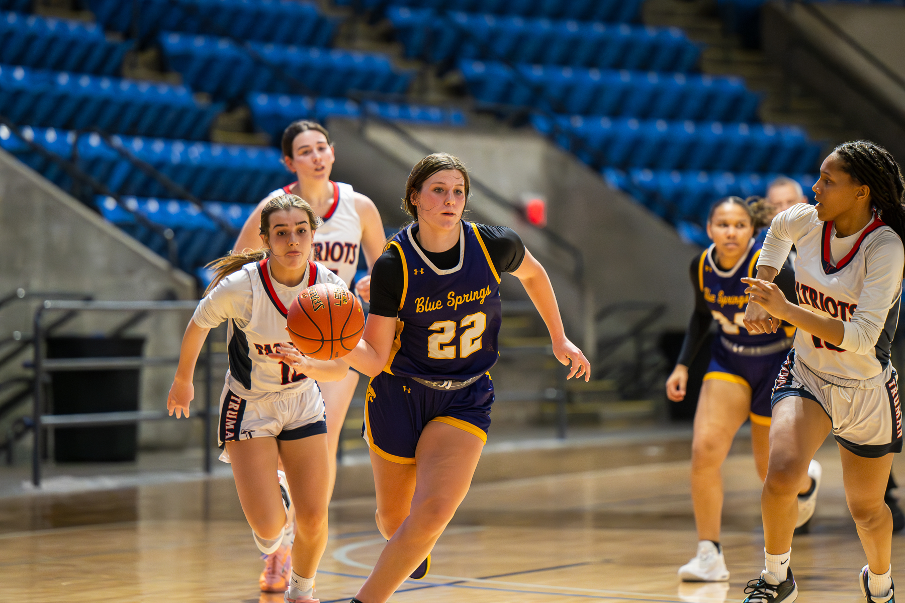 Blue Springs girls basketball player driving with the ball.