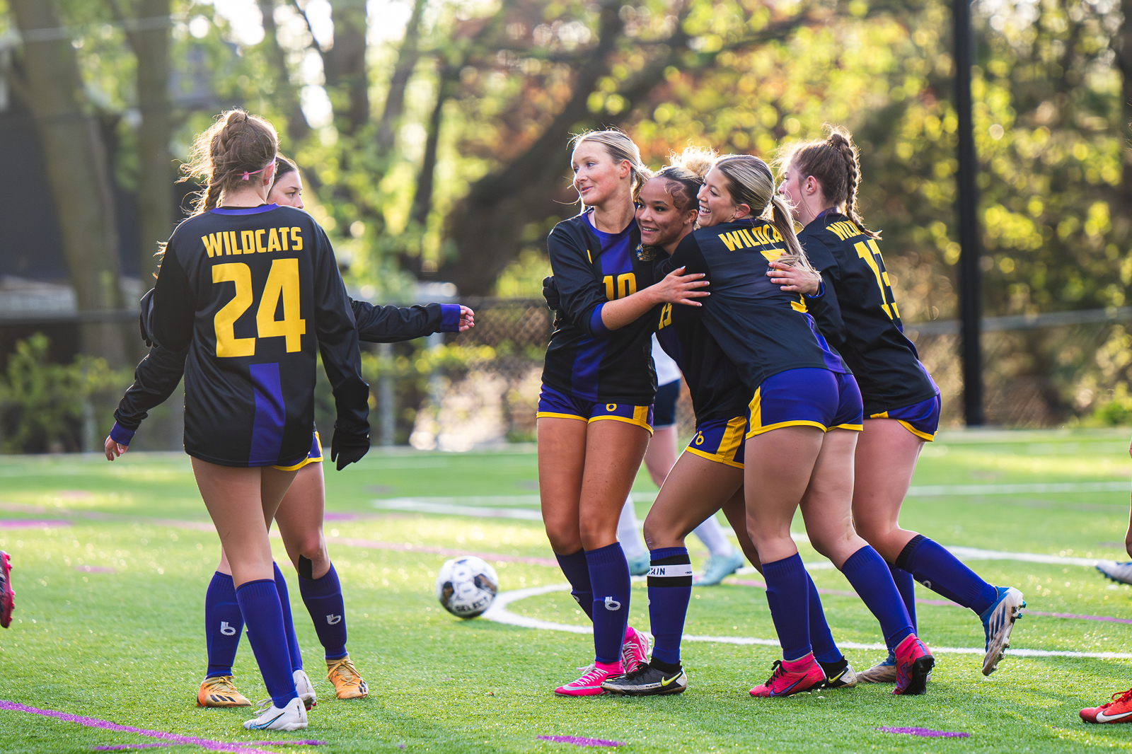 Blue Springs girls soccer players celebrating together.
