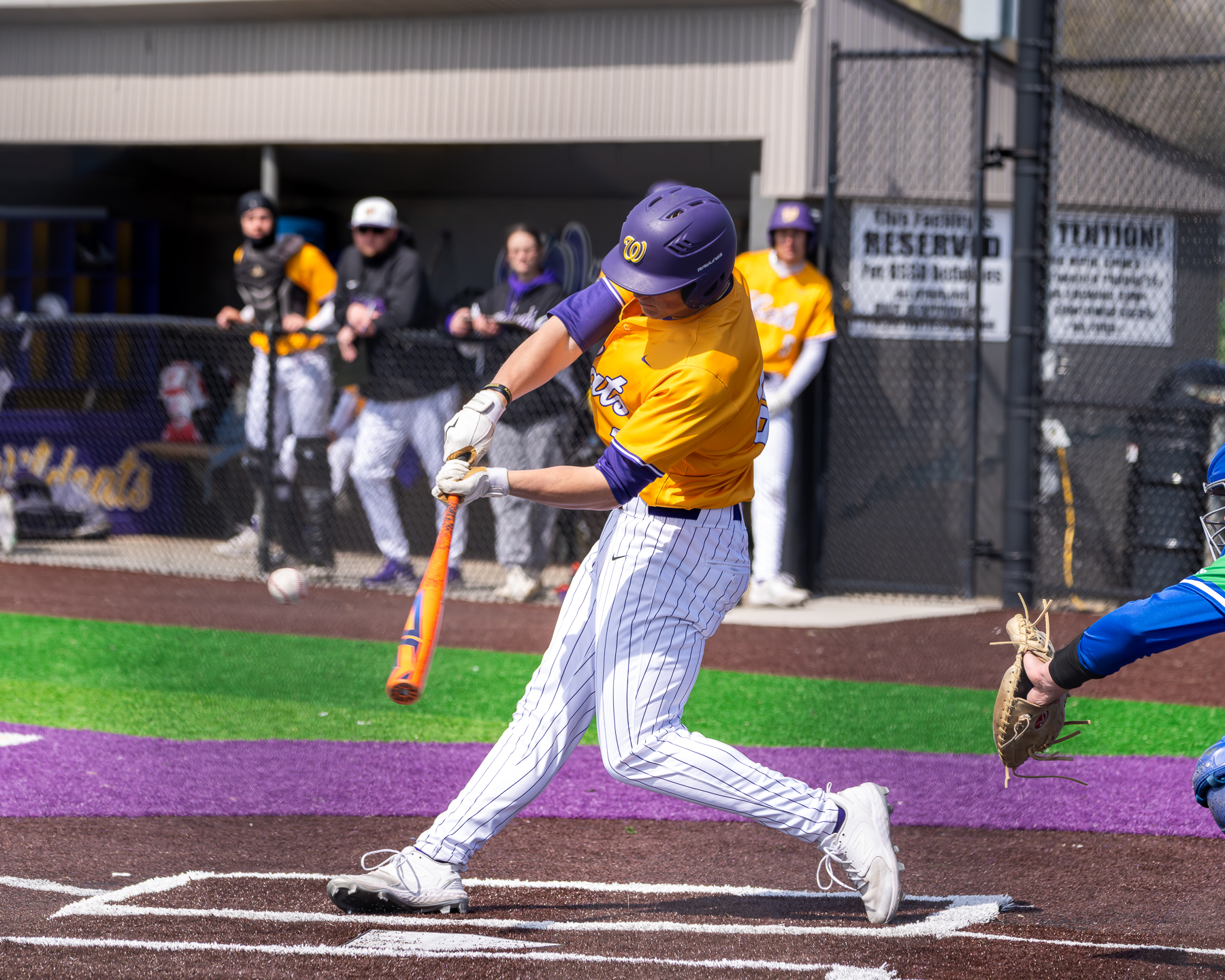 Blue Springs baseball player swinging at a pitch.