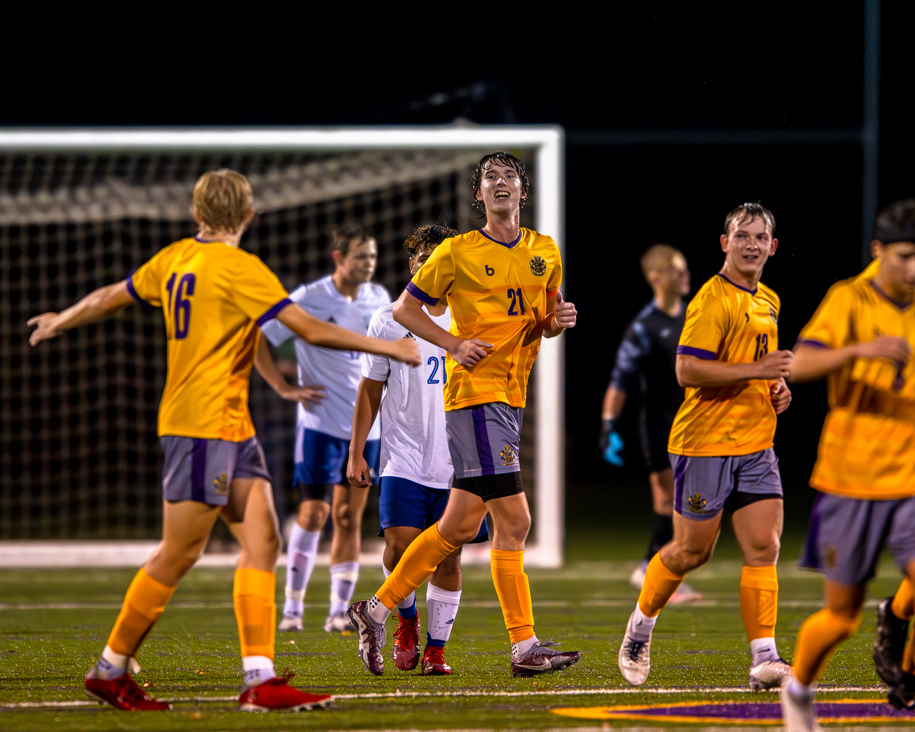 Blue Springs boys soccer players celebrating.
