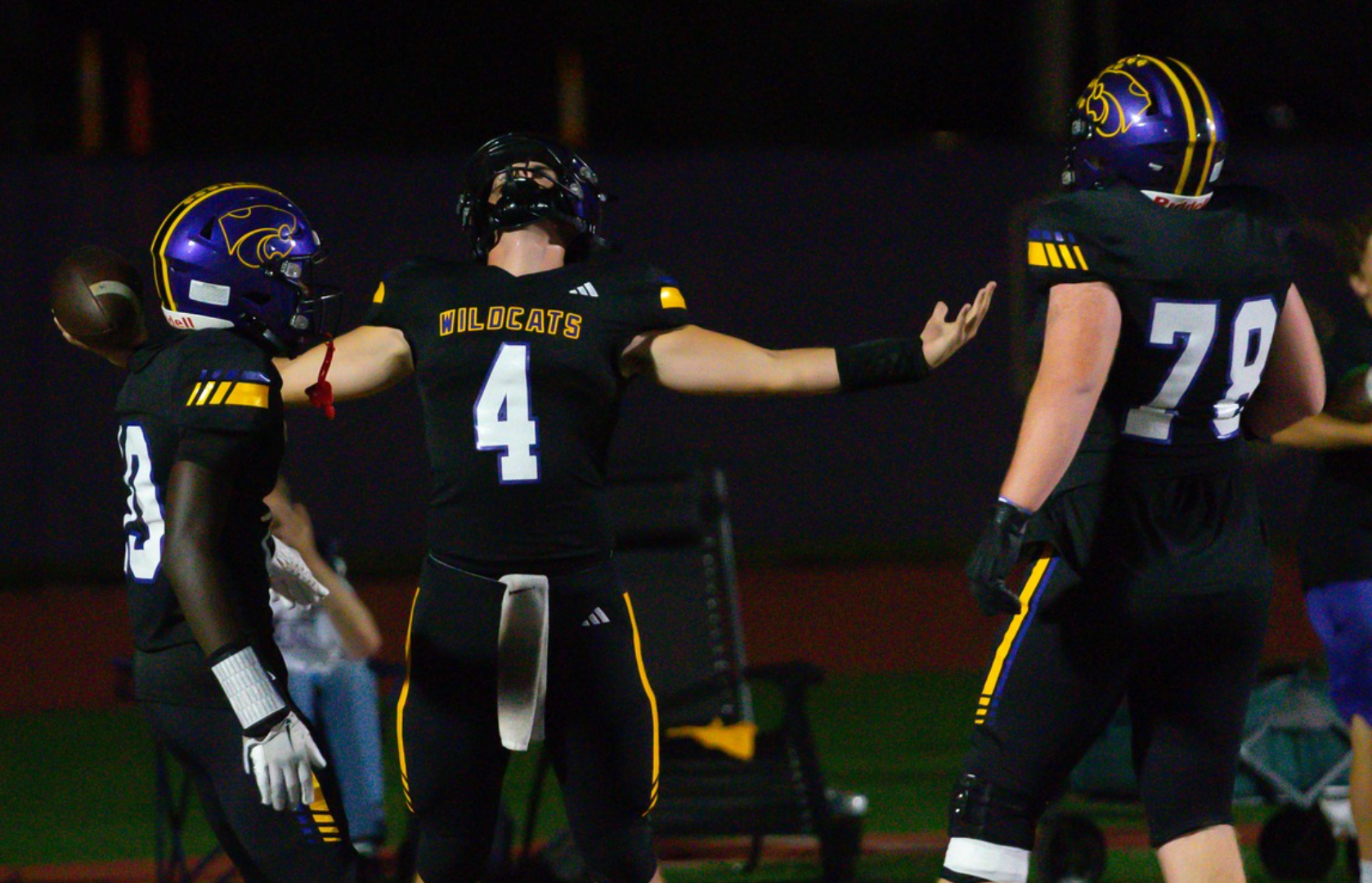 Blue Springs football players on the sideline.
