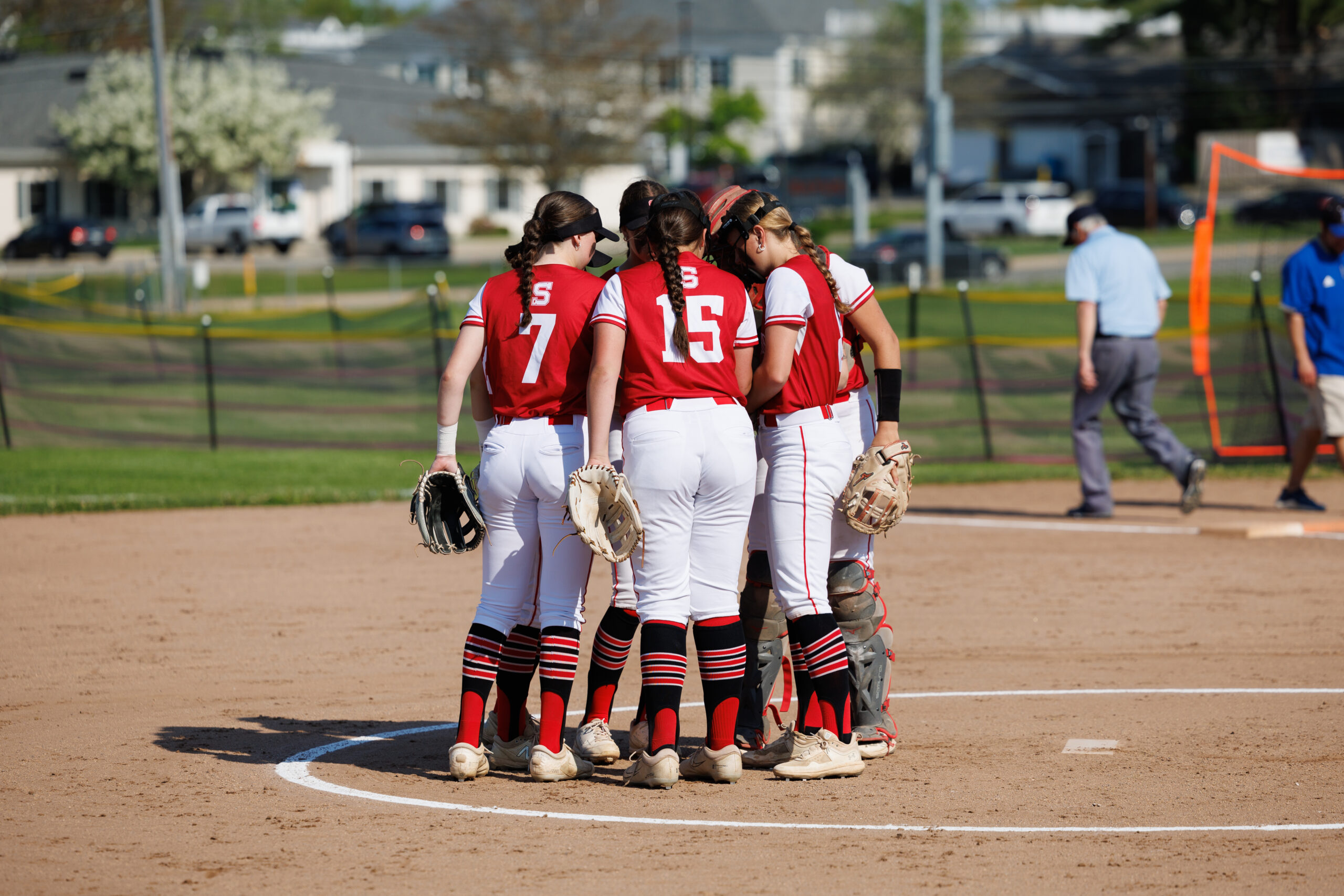 Softball Team In Huddle at PItchers Mound