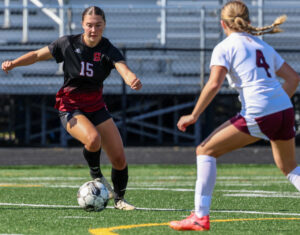 Girls Soccer dribbling against defender