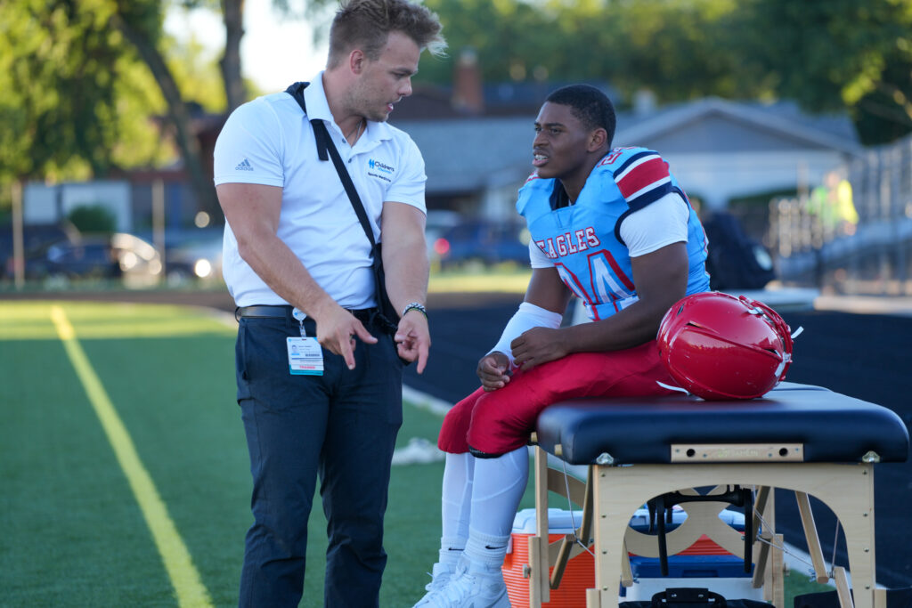 Trainer with Marshall Football Player