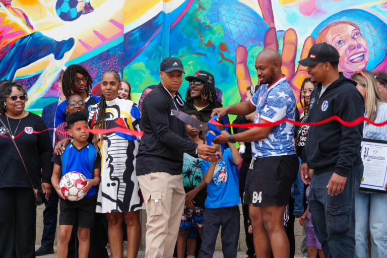 Members of Banks' family participating in the ceremonial ribbon cutting for the new mural