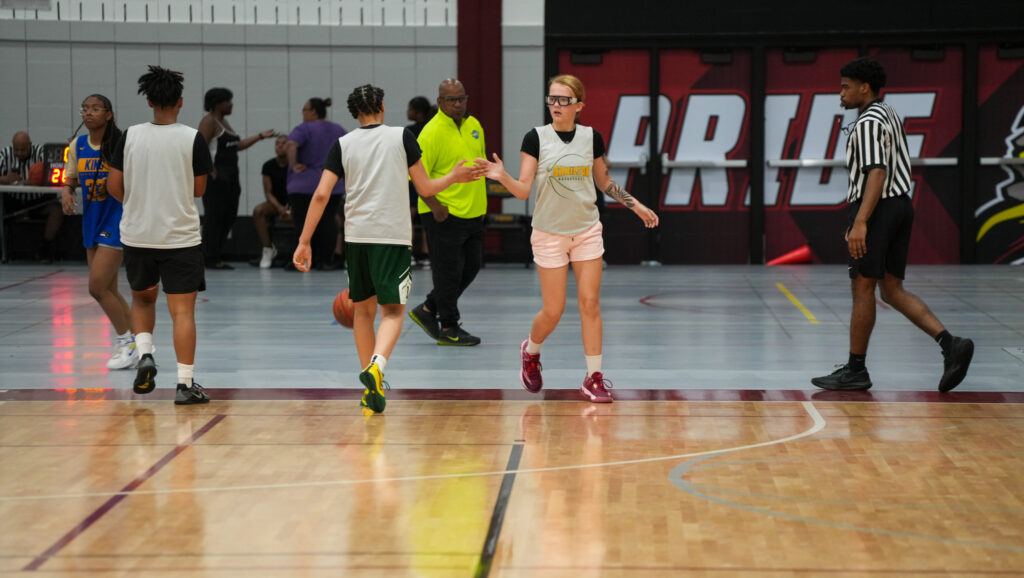 Hamilton teammates high-five during an MCC summer league basketball game.