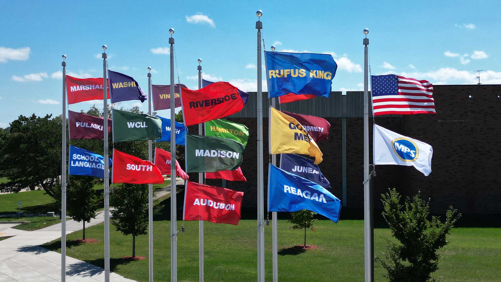 Flags for all MCC member schools fly outside Vincent Stadium