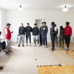 Quince Orchard varsity soccer team participates in an event at the Pleasant View Historical Site where they learned some of the history of the church and one-room school house as well as did clean-up of the grounds and helped reset furniture in the historic one-room school house	.