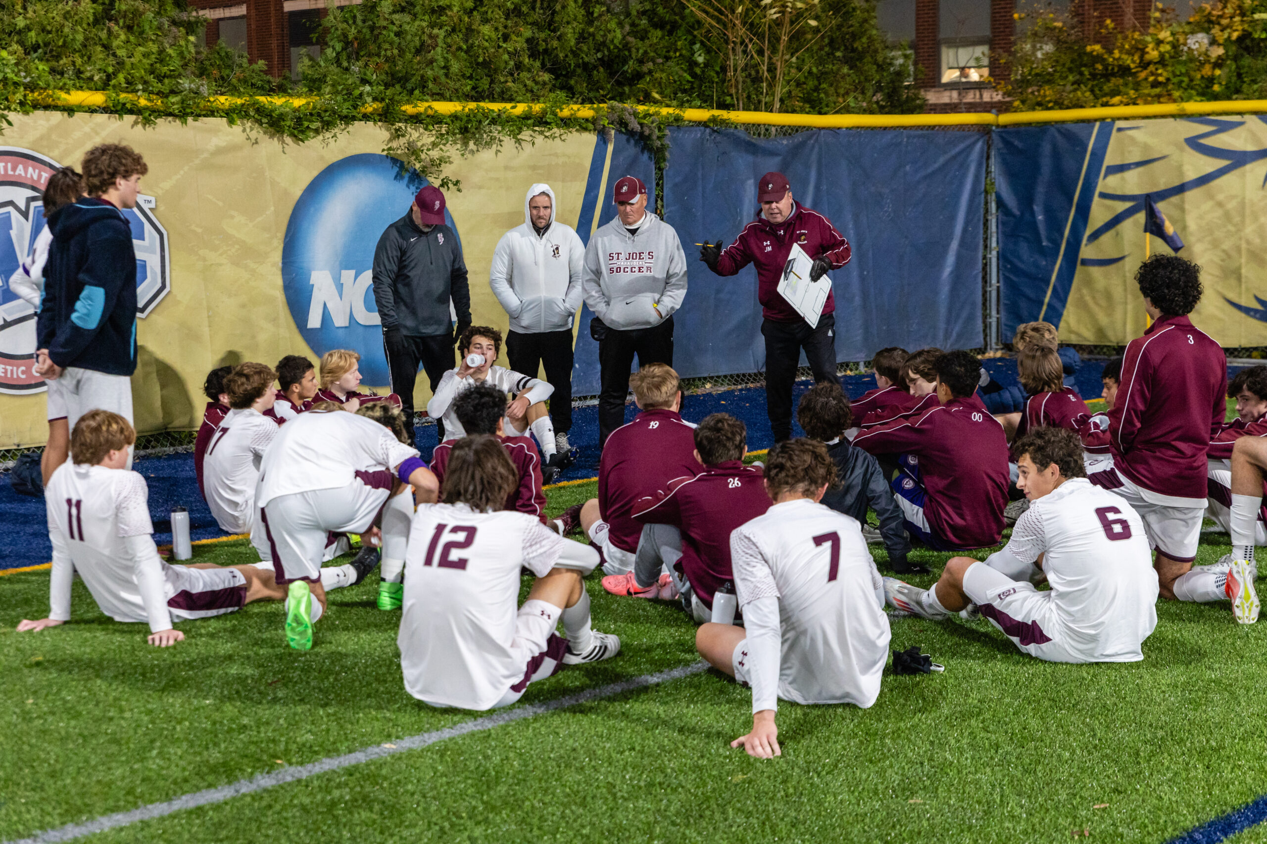 Team is addressed by Coach Thoin and staff