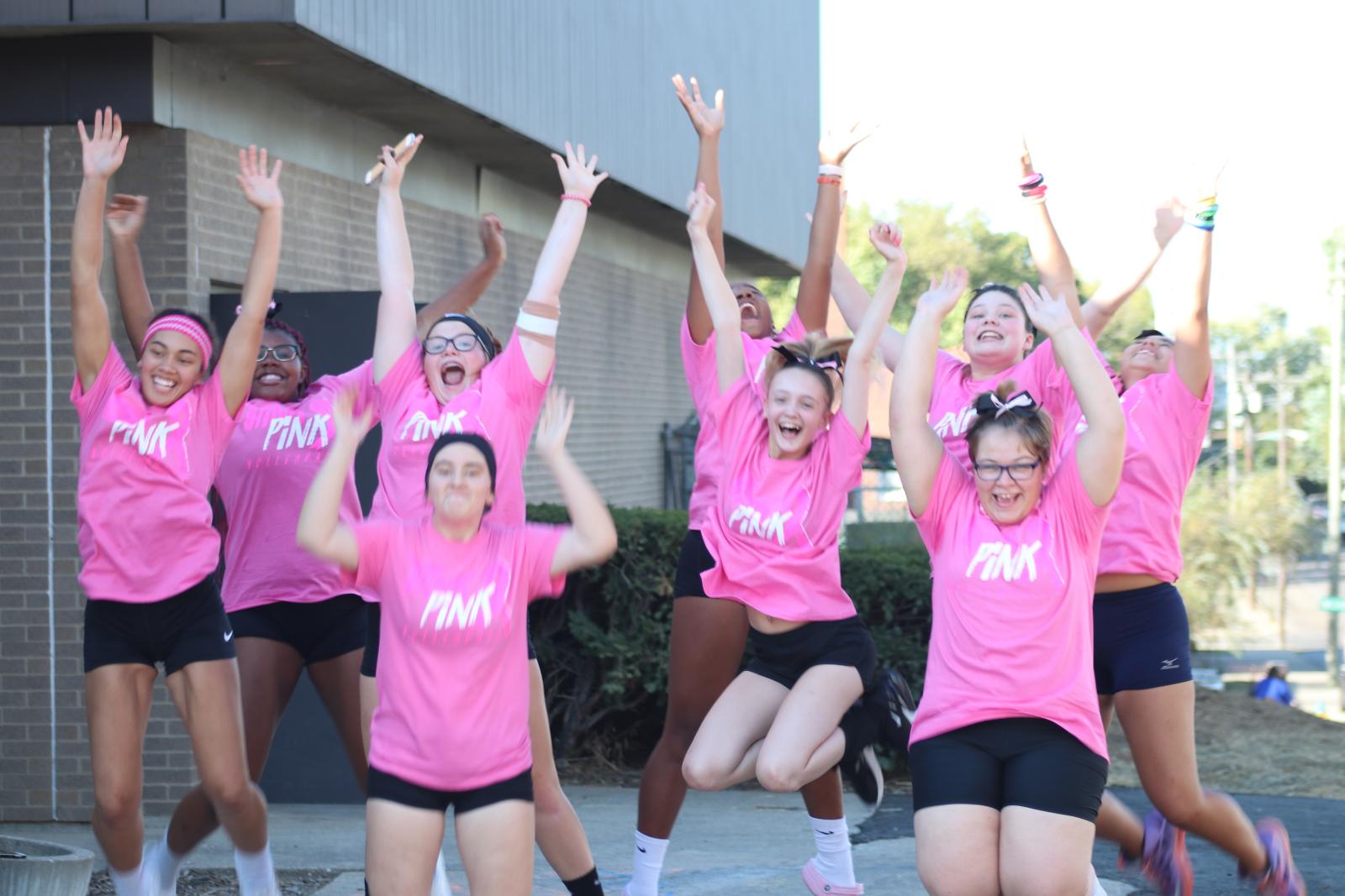 The SBEP volleyball team jumps in unison for a photo.