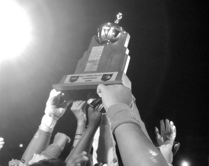 The SBEP football team holds up a trophy.