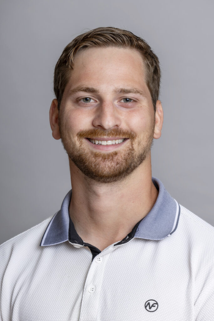 A man smiles for a portrait picture.