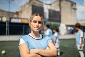 Portrait of a young female soccer player in a sports court