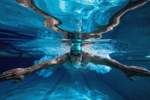 Photo of a competi0t0ive swimmer swimming.