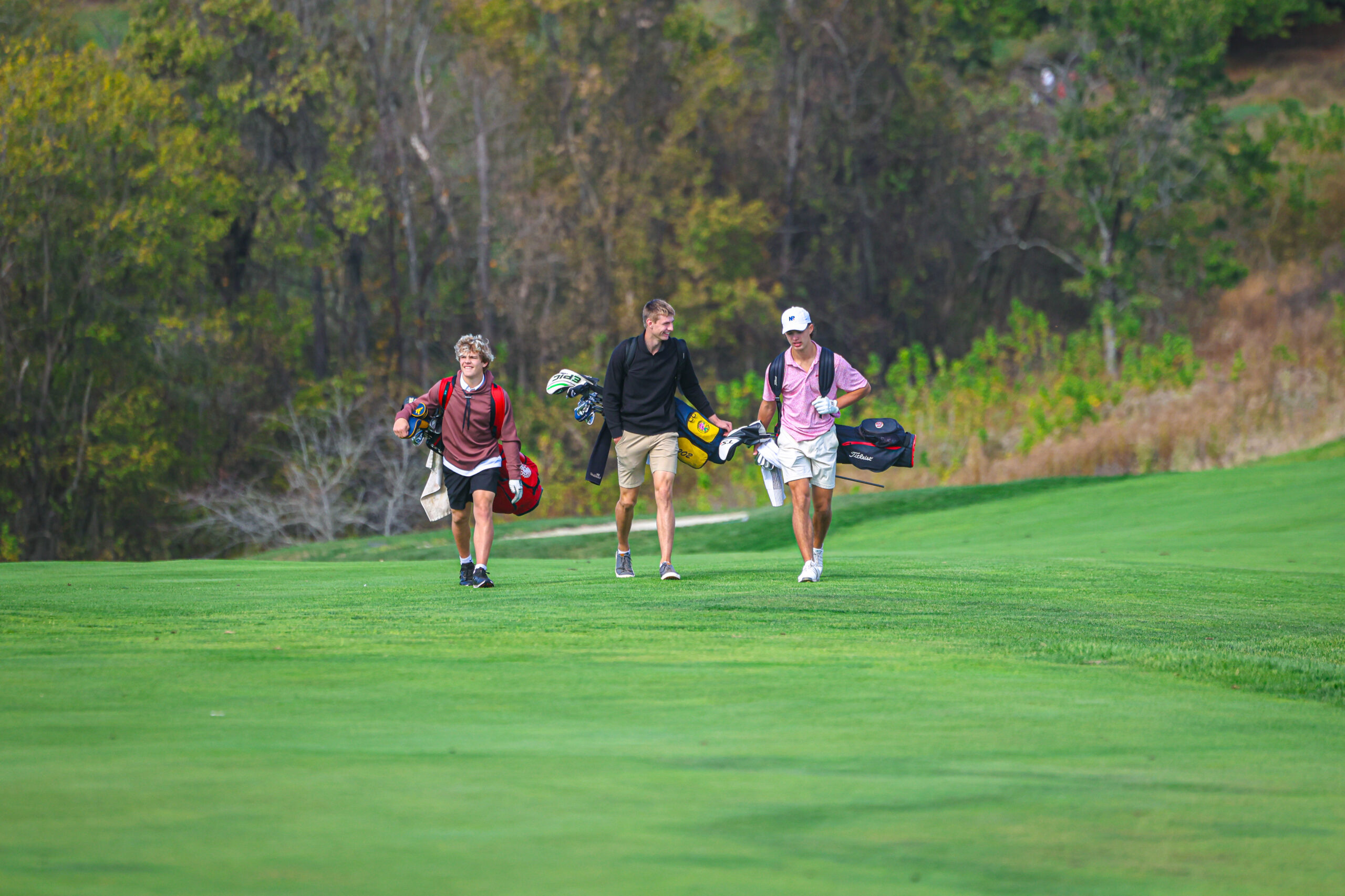 Golfers walking down the fairway.