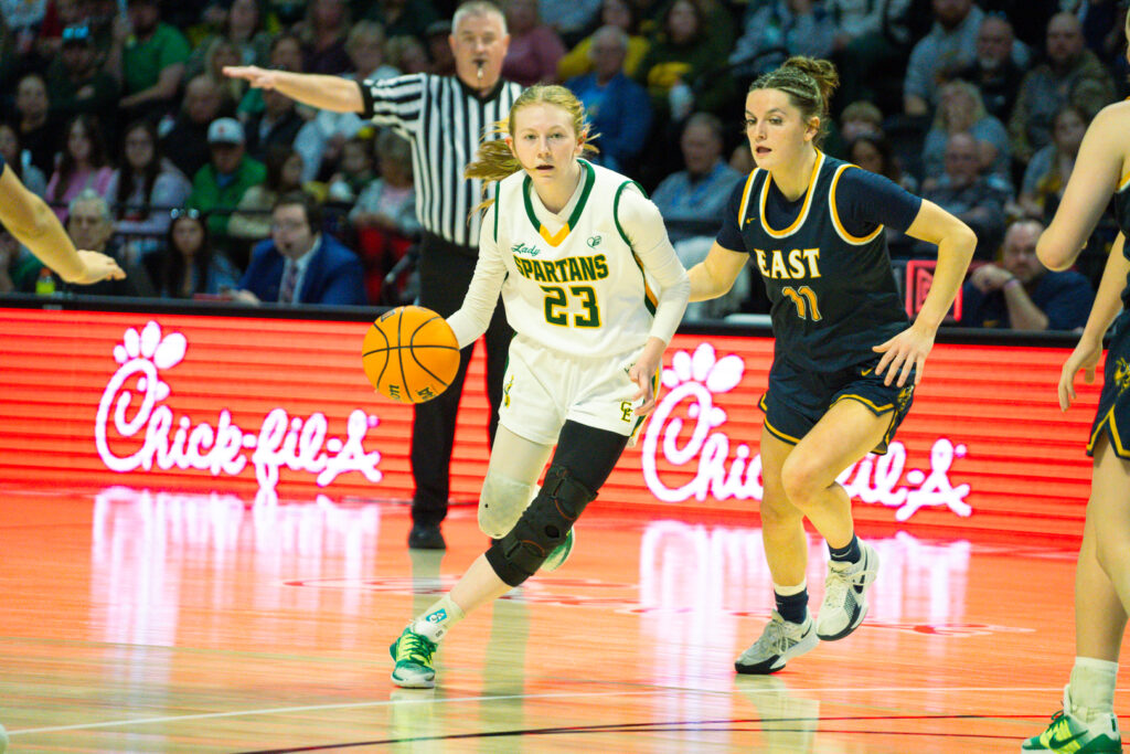 Spartans basketball player dribbling.