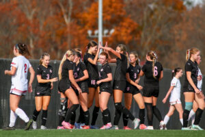 A soccer team celebrates a goal