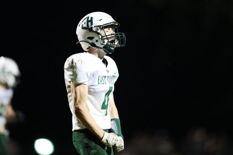 A football player celebrates a tackle.